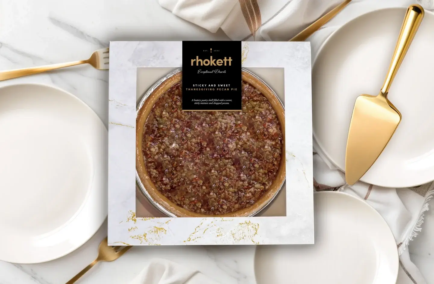 Rhokett pecan pie in its packaging styled with plates and a cake slice