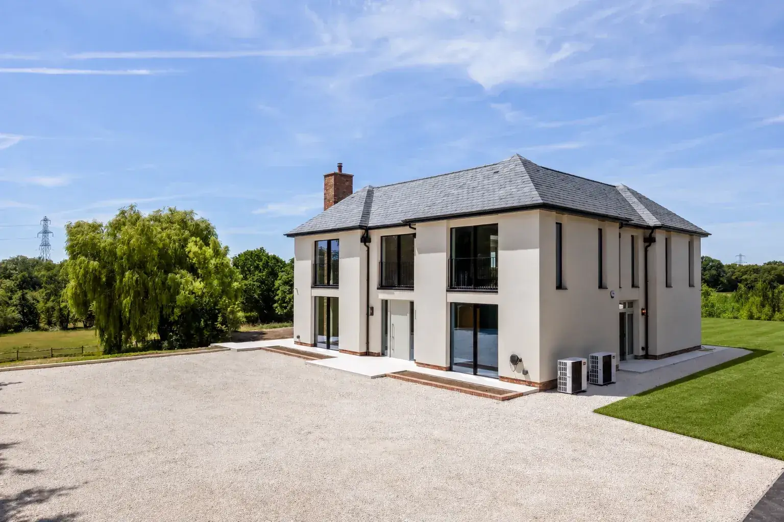 Modern Woodhart house with a slate roof and green lawn