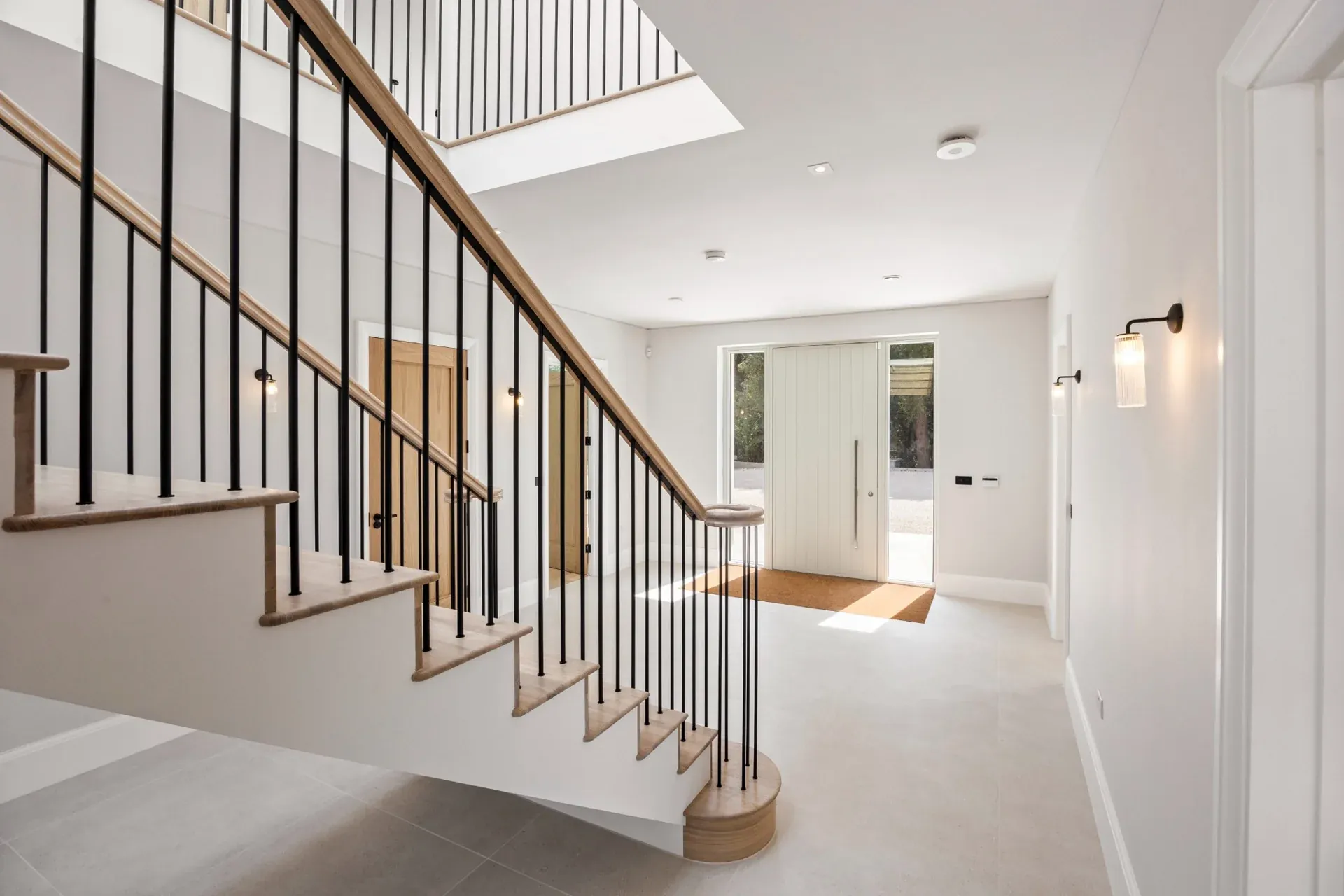 Streams Farm entrance hall with an oak staircase and black balustrades